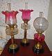 3 x ANTIQUE VICTORIAN/EDWARDIAN OIL LAMPS CRANBERRY GLASS COLLECTION ONLY PLEASE