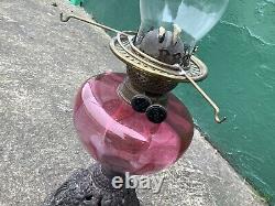A Beautiful Antique Art Nouveau Oil Lamp With Cranberry Glass Shade. 22 High
