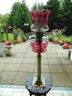 A Good Quality Victorian Cranberry Twin Duplex Oil Lamp