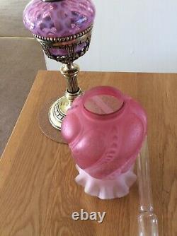 An Antique Cranberry Drop In Font Oil Lamp and Cranberry Shade