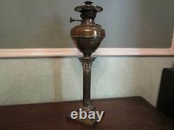 An antique brass Corinthian column oil lamp
