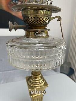 Antique bras art nouveau oil lamp with a facet cut clear font and duplex burner