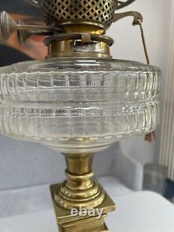 Antique bras art nouveau oil lamp with a facet cut clear font and duplex burner