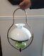 Antique hanging oil lamp. Green glass with gold detail. Brass frame