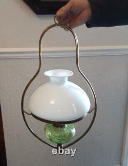 Antique hanging oil lamp. Green glass with gold detail. Brass frame