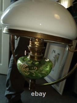 Antique hanging oil lamp. Green glass with gold detail. Brass frame