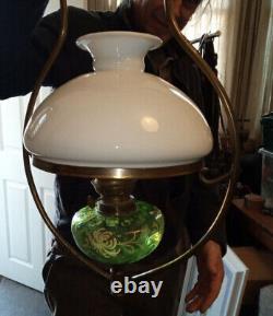 Antique hanging oil lamp. Green glass with gold detail. Brass frame