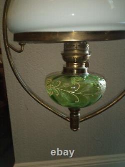 Antique hanging oil lamp. Green glass with gold detail. Brass frame