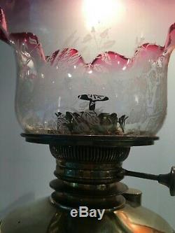 Antique tripod brass oil lamp art nouveau with cranberry ruffle top shade