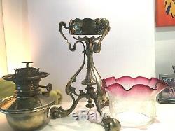 Antique tripod brass oil lamp art nouveau with cranberry ruffle top shade