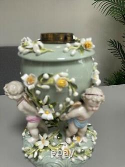 Green Sitzendorf porcelain oil lamp, 19th century. Cherubs putti