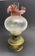 Messengers Harrods Brass Oil Lamp with Cranberry Glass Shade, and Chimney