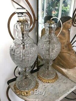 Pair of large antique cut glass table lamps with gilded brass fretwork bases