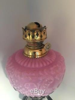 Victorian metal figural oil lamp with a embossed pink fount and funnel