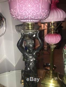 Victorian metal figural oil lamp with a embossed pink fount and funnel