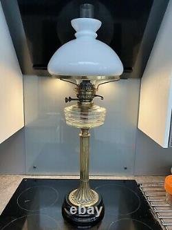 Victorian oil lamp Corrinthian brass stand on black glass base 75cm tall