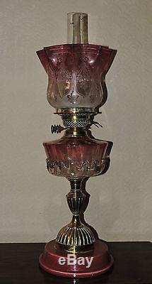 Victorian twin burner oil lamp with a Cranberry font and shade