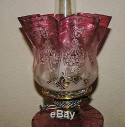 Victorian twin burner oil lamp with a Cranberry font and shade